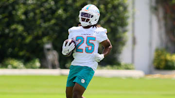 Jun 4, 2024; Miami Gardens, FL, USA; Miami Dolphins running back Jaylen Wright (25) runs with the football during mandatory minicamp at Baptist Health Training Complex. Mandatory Credit: Sam Navarro-Imagn Images
