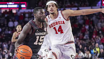 Jan 11, 2025; Athens, Georgia, USA; Oklahoma Sooners guard Duke Miles (15) dribbles against Georgia Bulldogs forward Asa Newell (14) during the second half at Stegeman Coliseum. Mandatory Credit: Dale Zanine-Imagn Images
