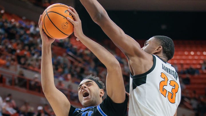 Feb 17, 2024; Stillwater, Oklahoma, USA; Oklahoma State Cowboys center Brandon Garrison (23) defends a shot by Brigham Young Cougars center Aly Khalifa (50) during the second half at Gallagher-Iba Arena. Mandatory Credit: William Purnell-USA TODAY Sports