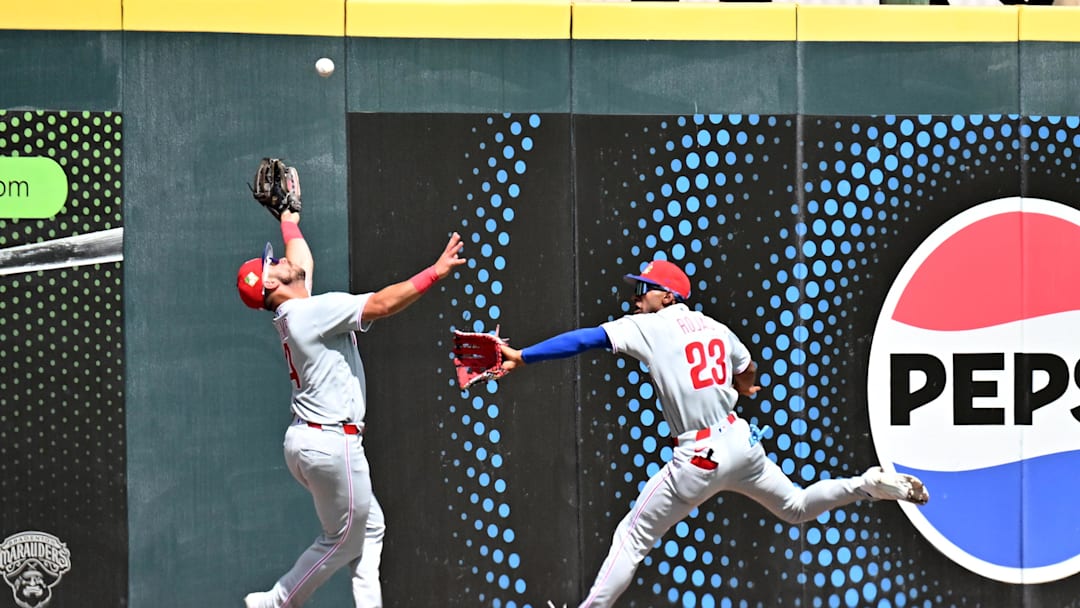 Philadelphia Phillies left fielder Otto Kemp (4) and center fielder Johan Rojas (23) chase down a fly ball.