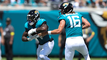 Sep 7, 2025; Jacksonville, Florida, USA; Jacksonville Jaguars quarterback Trevor Lawrence (16) hands off to running back Tank Bigsby (4) against the Carolina Panthers during the first half at EverBank Stadium. Mandatory Credit: Morgan Tencza-Imagn Images