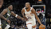Mar 28, 2025; Minneapolis, Minnesota, USA; Phoenix Suns forward Kevin Durant (35) brings the ball up as Minnesota Timberwolves guard Anthony Edwards (5) defends him in the fourth quarter at Target Center. Mandatory Credit: Bruce Kluckhohn-Imagn Images