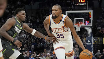 Mar 28, 2025; Minneapolis, Minnesota, USA; Phoenix Suns forward Kevin Durant (35) brings the ball up as Minnesota Timberwolves guard Anthony Edwards (5) defends him in the fourth quarter at Target Center. Mandatory Credit: Bruce Kluckhohn-Imagn Images