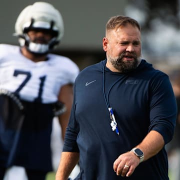 Penn State Nittany Lions offensive coordinator Andy Kotelnicki talks with players during a practice session outside Holuba Hall.