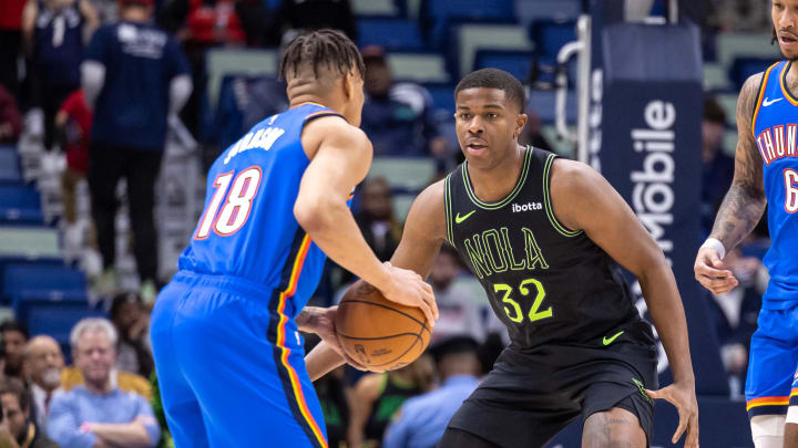 Jan 26, 2024; New Orleans, Louisiana, USA; Oklahoma City Thunder forward Keyontae Johnson (18) dribbles against New Orleans Pelicans forward E.J. Liddell (32) during the second half at Smoothie King Center. Mandatory Credit: Stephen Lew-USA TODAY Sports