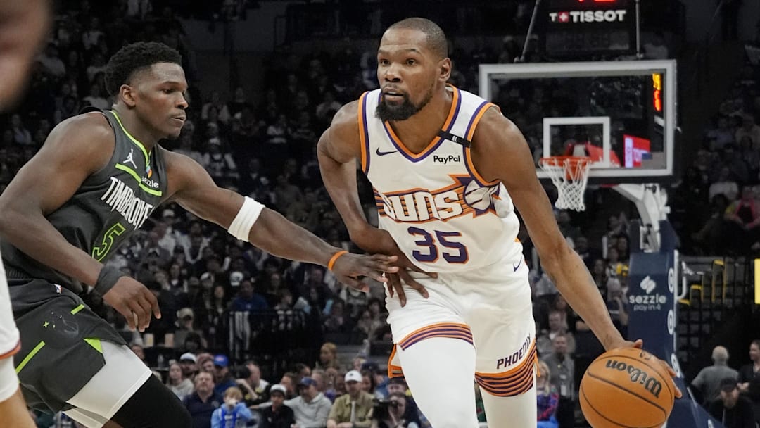 Mar 28, 2025; Minneapolis, Minnesota, USA; Phoenix Suns forward Kevin Durant (35) brings the ball up as Minnesota Timberwolves guard Anthony Edwards (5) defends him in the fourth quarter at Target Center. Mandatory Credit: Bruce Kluckhohn-Imagn Images