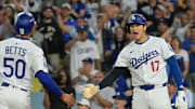 Oct 1, 2025; Los Angeles, California, USA; Los Angeles Dodgers shortstop Mookie Betts (50) and designated hitter Shohei Ohtani (17) celebrate after scoring against the Cincinnati Reds in the sixth inning during game two of the Wildcard round for the 2025 MLB playoffs at Dodger Stadium. Mandatory Credit: Jayne Kamin-Oncea-Imagn Images