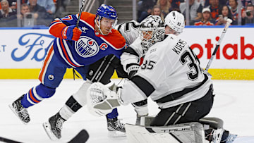Edmonton Oilers forward Connor McDavid tries to find a loose puck in front of Los Angeles Kings goaltender Darcy Kuemper.