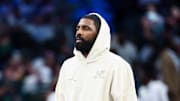 Oct 22, 2025; Dallas, Texas, USA;  Dallas Mavericks injured guard Kyrie Irving walks across the court during the game against the San Antonio Spurs at American Airlines Center. Mandatory Credit: Kevin Jairaj-Imagn Images