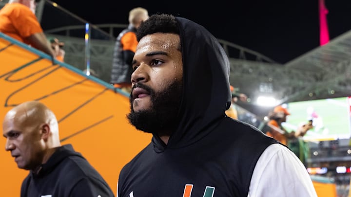 Jan 19, 2026; Miami Gardens, FL, USA; Miami Hurricanes defensive lineman Akheem Mesidor (3) with coach Jason Taylor against the Indiana Hoosiers during the College Football Playoff National Championship game at Hard Rock Stadium. Mandatory Credit: Mark J. Rebilas-Imagn Images