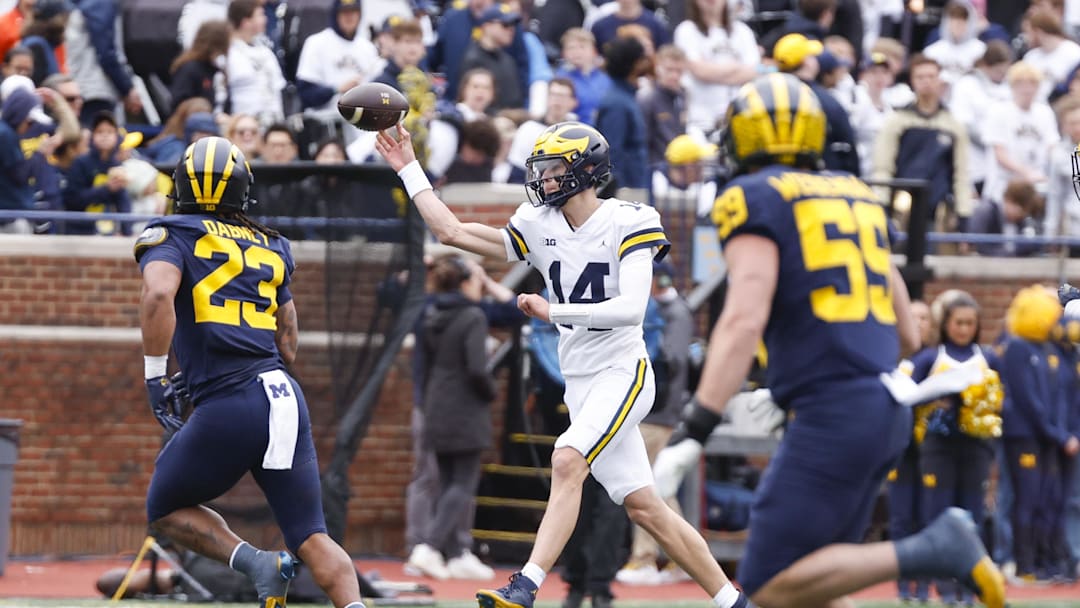 Apr 18, 2026; Ann Arbor, MI, USA; Michigan Wolverines quarterback Tommy Carr (14) passes the ball during the second half at Michigan Stadium. Mandatory Credit: Brian Bradshaw Sevald-Imagn Images