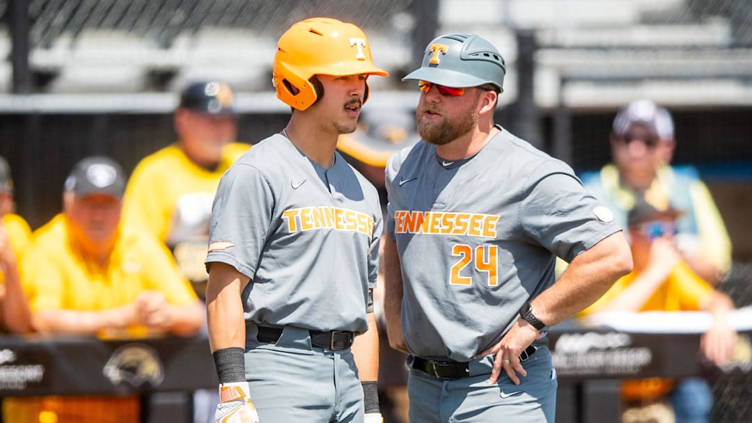 Tennessee assistant coach Josh Elander (24) speaks with Tennessee outfielder Hunter Ensley (9) during game one of the NCAA baseball super regional between Tennessee and Southern Mississippi held at Pete Taylor Park in Hattiesburg, Miss., on Sunday, June 11, 2023.