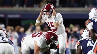 Nov 29, 2025; Auburn, Alabama, USA; Alabama Crimson Tide quarterback Ty Simpson (15) talks to teammates during the first half against the Auburn Tigers at Jordan-Hare Stadium. Mandatory Credit: John Reed-Imagn Images