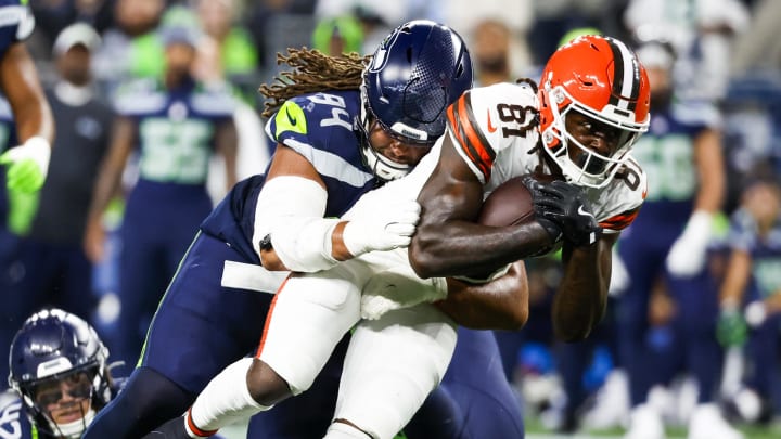 Aug 24, 2024; Seattle, Washington, USA; Seattle Seahawks defensive end Mike Morris (94) tackles Cleveland Browns wide receiver Michael Woods II (81) following a reception by Woods II during the second quarter at Lumen Field. Mandatory Credit: Joe Nicholson-USA TODAY Sports