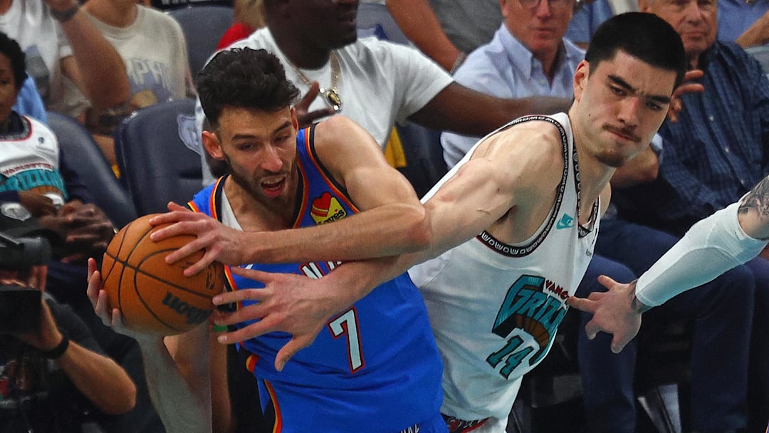 Apr 24, 2025; Memphis, Tennessee, USA; Oklahoma City Thunder forward Chet Holmgren (7) and Memphis Grizzlies center Zach Edey (14) battle for a rebound during the first quarter during game three for the first round of the 2024 NBA Playoffs at FedExForum. Mandatory Credit: Petre Thomas-Imagn Images