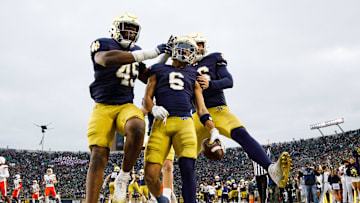 Notre Dame defensive lineman Kobi Onyiuke (45), wide receiver Jordan Faison (6) and wide receiver Alex Whitman (86) celebrate a Faison touchdown on fake punt play that would later be called back during a NCAA college football game against Virginia at Notre Dame Stadium on Saturday, Nov. 16, 2024, in South Bend.