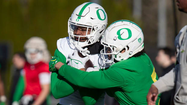 Oregon defensive back Kobe Savage wraps up wide receiver Traeshon Holden during spring camp for the Oregon Ducks Thursday, Ma