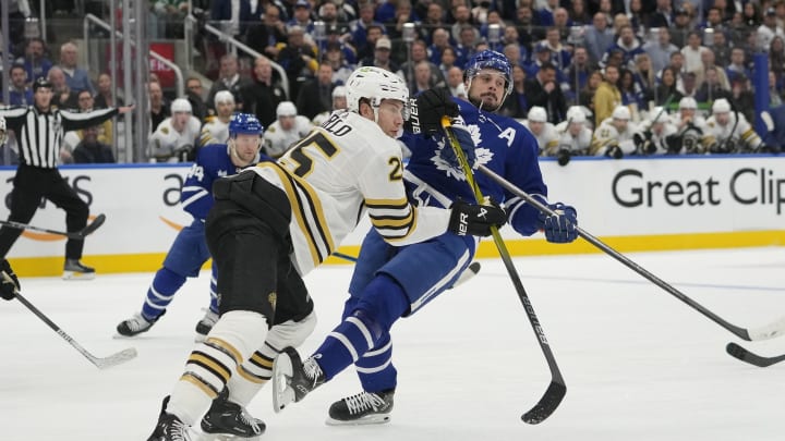 Apr 24, 2024; Toronto, Ontario, CAN; Boston Bruins defenseman Brandon Carlo (25) checks Toronto Maple Leafs forward Auston Matthews (34) during the first period of game three of the first round of the 2024 Stanley Cup Playoffs at Scotiabank Arena. Mandatory Credit: John E. Sokolowski-USA TODAY Sports