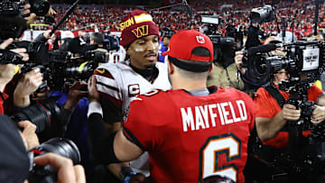 Washington Commanders quarterback Jayden Daniels greets Tampa Bay Buccaneers star Baker Mayfield at NFL playoff game