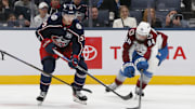 Oct 16, 2025; Columbus, Ohio, USA; Colorado Avalanche defenseman Brent Burns (84) reaches for the puck under the stick of Columbus Blue Jackets right wing Yegor Chinakhov (59) during the third period at Nationwide Arena. Mandatory Credit: Russell LaBounty-Imagn Images