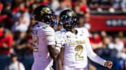 Oct 19, 2024; Tucson, Arizona, USA; Colorado Buffalos quarterback Shedeur Sanders (2) with wide receiver Travis Hunter (12) against the Arizona Wildcats at Arizona Stadium.