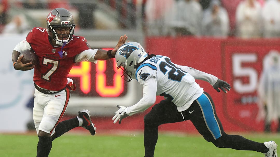 Jan 3, 2026; Tampa, Florida, USA; Tampa Bay Buccaneers running back Bucky Irving (7) runs against Carolina Panthers cornerback Chau Smith-Wade (26) in the first half at Raymond James Stadium. Mandatory Credit: Nathan Ray Seebeck-Imagn Images