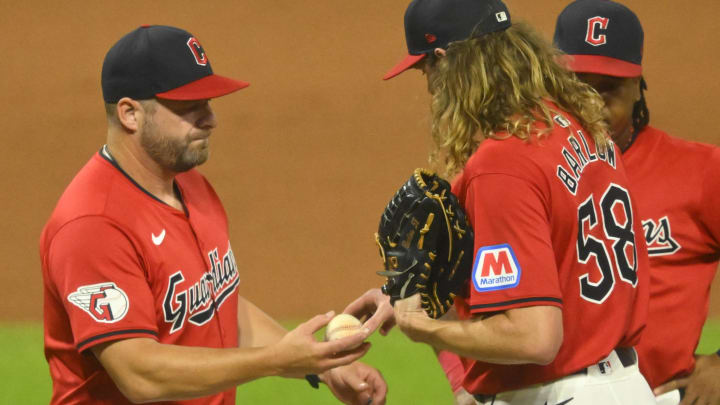 Aug 27, 2024; Cleveland, Ohio, USA; Cleveland Guardians manager Stephen Vogt (12) takes the ball from relief pitcher Scott Barlow (58) during a pitching change in the seventh inning against the Kansas City Royals at Progressive Field. Mandatory Credit: David Richard-USA TODAY Sports