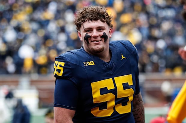 Blue Team defensive lineman Mason Graham (55) walks up the tunnel for halftime during the spring game at Michigan Stadium in 