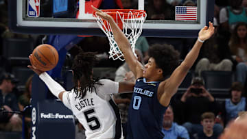 Feb 3, 2025; Memphis, Tennessee, USA; Memphis Grizzlies forward Jaylen Wells (0) defends as San Antonio Spurs guard Stephon Castle (5) drives to the basket during the second quarter at FedExForum. Mandatory Credit: Petre Thomas-Imagn Images