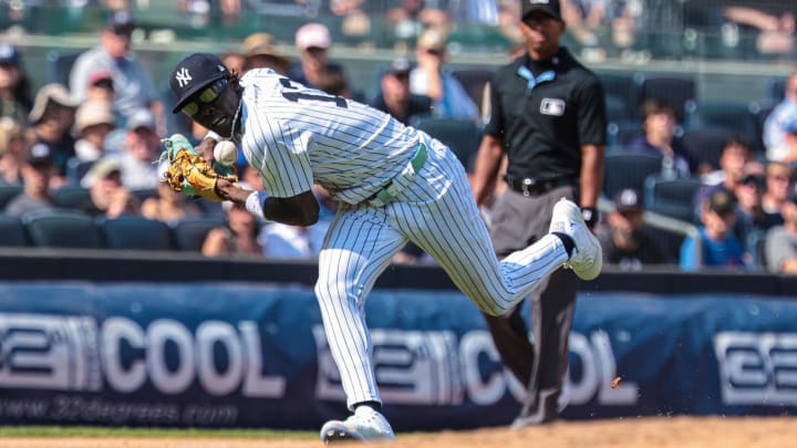 Aug 11, 2024; Bronx, New York, USA; New York Yankees third baseman Jazz Chisholm Jr. (13) can not field the ball during the seventh inning against the Texas Rangers  at Yankee Stadium. Mandatory Credit: Vincent Carchietta-USA TODAY Sports