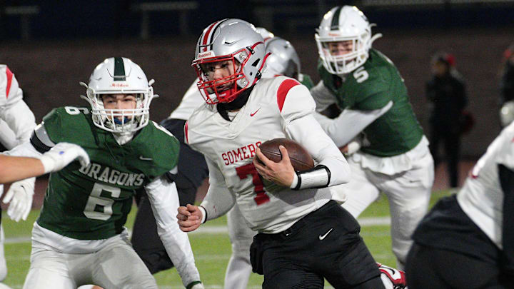 Somers quarterback Miguel Inglesias (7) looks for some running room in the Cornwall defense during the Class A NYSPHSAA East semifinal at Middletown High School Nov. 29, 2024. Somers quarterback Miguel Inglesias (7) looks for some running room in the Cornwall defense during the Class A NYSPHSAA East semifinal at Middletown High School Nov. 29, 2024.