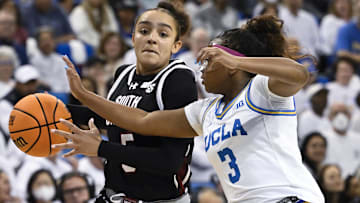 Nov 24, 2024; Los Angeles, California, USA; South Carolina Gamecocks guard Tessa Johnson (5) drives to the basket as UCLA Bruins guard Londynn Jones (3) moves in to defend during the third quarter at Pauley Pavilion presented by Wescom. Mandatory Credit: Robert Hanashiro-Imagn Images