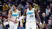 Dec 31, 2024; Indianapolis, Indiana, USA; Indiana Pacers guard Bennedict Mathurin (00) celebrates a made shot with  guard Tyrese Haliburton (0)  in the second half against the Milwaukee Bucks at Gainbridge Fieldhouse. Mandatory Credit: Trevor Ruszkowski-Imagn Images