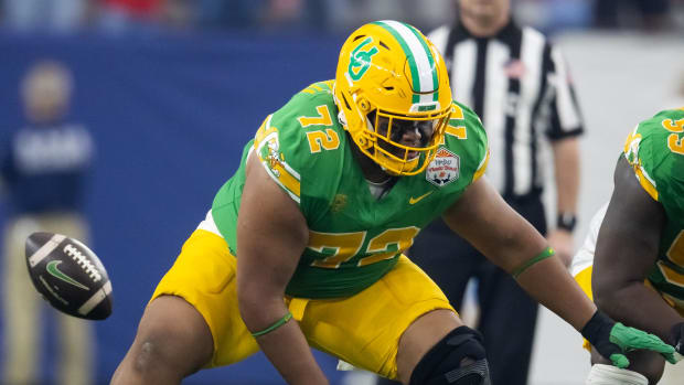 Jan 1, 2024; Glendale, AZ, USA; Oregon Ducks offensive lineman Iapani Laloulu (72) snaps the ball against the Liberty Flames 