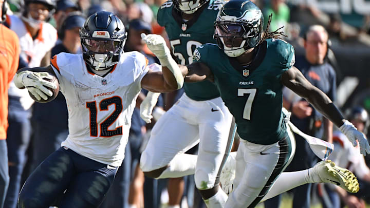 Denver Broncos running back RJ Harvey (12) runs past Philadelphia Eagles cornerback Kelee Ringo (7) at Lincoln Financial Field.