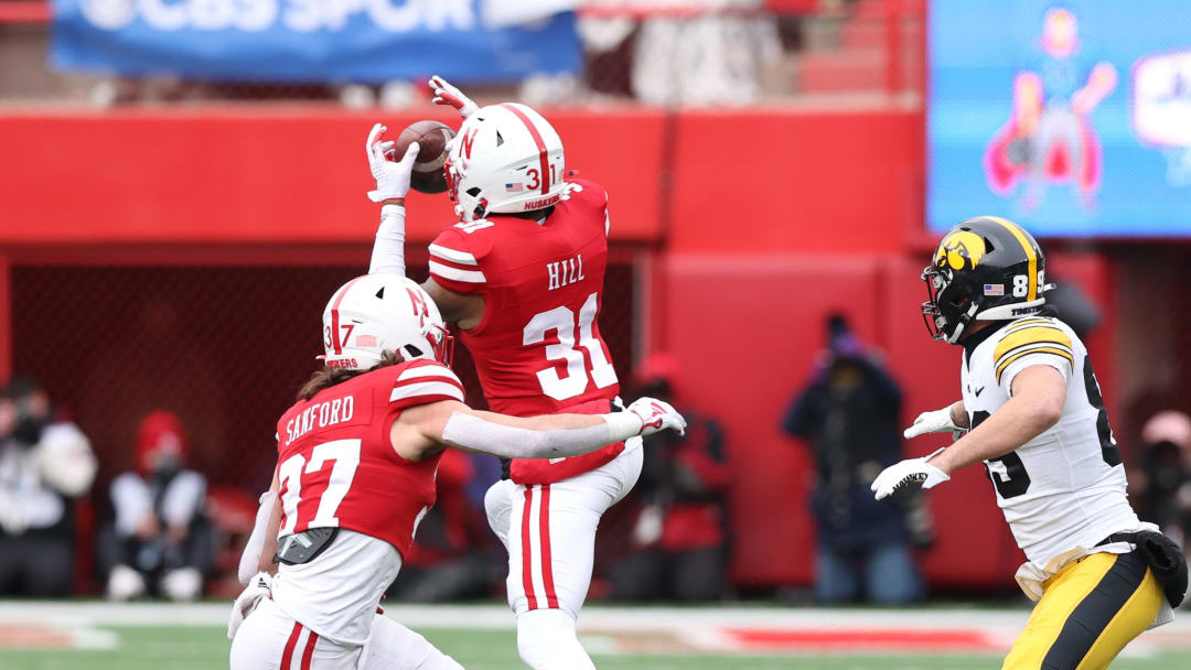 Nov 24, 2023; Lincoln, Nebraska, USA; Nebraska Cornhuskers defensive back Tommi Hill (31) intercepts a pass intended for Iowa Hawkeyes wide receiver Nico Ragaini (89) at Memorial Stadium.