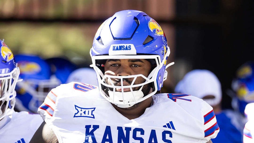 Nov 8, 2025; Tucson, Arizona, USA; Kansas Jayhawks offensive lineman Kobe Baynes (70) against the Arizona Wildcats at Arizona Stadium. Mandatory Credit: Mark J. Rebilas-Imagn Images