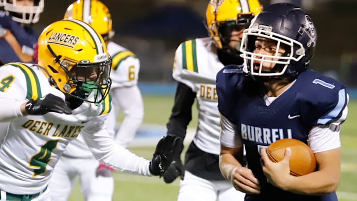 Burrell's Antonio Perkins, right, set a school record by rushing for 360 yards Friday night at Burrell High School. The Buccaneers' sophomore also set a school record by scoring seven touchdowns in a win over Deer Lakes.