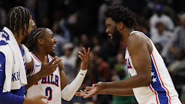 Oct 28, 2025; Washington, District of Columbia, USA; Philadelphia 76ers guard Tyrese Maxey (0) celebrates with 76ers center Joel Embiid (21) during a stoppage in play against the Washington Wizards in overtime at Capital One Arena. Mandatory Credit: Geoff Burke-Imagn Images