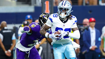 Sep 22, 2024; Arlington, Texas, USA;  Dallas Cowboys wide receiver CeeDee Lamb (88) runs with the ball as Baltimore Ravens cornerback Nate Wiggins (2) defends during the first half at AT&T Stadium. Mandatory Credit: Kevin Jairaj-Imagn Images