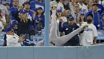 Oct 25, 2024; Los Angeles, California, USA; New York Yankees outfielder Alex Verdugo (24) reaches for a ball and collides into the wall in the tenth inning against the Los Angeles Dodgers during game one of the 2024 MLB World Series at Dodger Stadium. 
