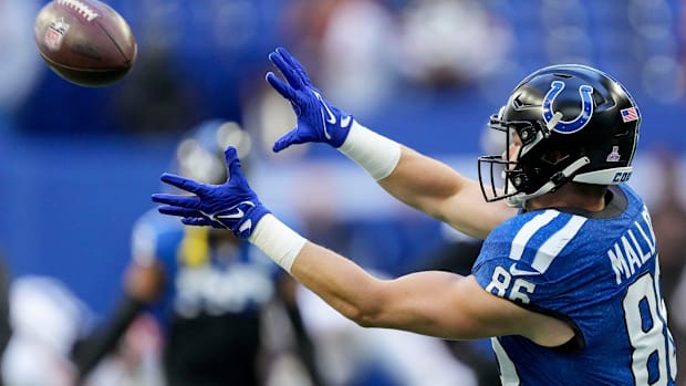 Colts tight end Will Mallory (blue jersey) gets ready to catch a pass during warmups.