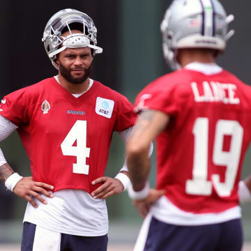 Jun 4, 2024; Frisco, TX, USA; Dallas Cowboys quarterback Dak Prescott (4) and quarterback Trey Lance (19) stand on the field during practice at the Ford Center at the Star Training Facility in Frisco, Texas.