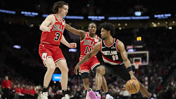 Jan 19, 2025; Portland, Oregon, USA; Portland Trail Blazers guard Scoot Henderson (00) drives past Chicago Bulls guard Josh Giddey (3) and guard Ayo Dosunmu (11) : Troy Wayrynen-Imagn Images