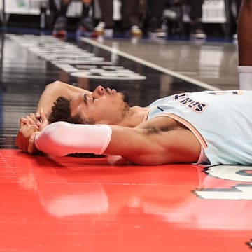 Dec 27, 2024; Brooklyn, New York, USA;  San Antonio Spurs center Victor Wembanyama (1) lays on the court after getting fouled in the third quarter against the Brooklyn Nets at Barclays Center. Mandatory Credit: Wendell Cruz-Imagn Images