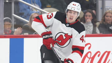 Mar 15, 2025; Pittsburgh, Pennsylvania, USA;  New Jersey Devils defenseman Luke Hughes (43) skates with the puck against the Pittsburgh Penguins during the second period at PPG Paints Arena. Mandatory Credit: Charles LeClaire-Imagn Images