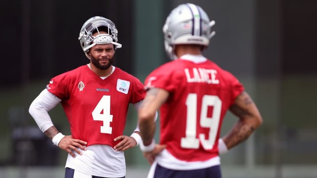 Dallas Cowboys quarterback Dak Prescott (4) and quarterback Trey Lance (19) stand on the field during practice