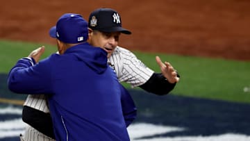 Oct 28, 2024; New York, New York, USA; New York Yankees manager Aaron Boone (17) and Los Angeles Dodgers manager Dave Roberts (30) hug before game three of the 2024 MLB World Series at Yankee Stadium. 
