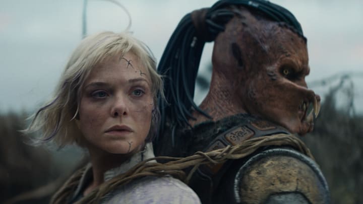 (L-R) Thia (Elle Fanning) and Dek (Dimitrius Schuster-Koloamatangi) in 20th Century Studios' PREDATOR: BADLANDS film