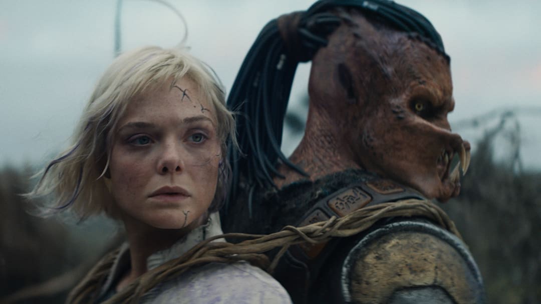 (L-R) Thia (Elle Fanning) and Dek (Dimitrius Schuster-Koloamatangi) in 20th Century Studios' PREDATOR: BADLANDS film.